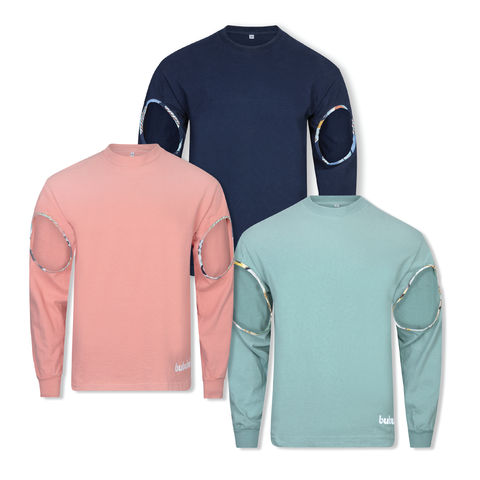 Three shirts next to each other against a white background, in salmon, fern green and navy blue, with each shirt showing cut-outs on the arms and a bubuleh logo on the bottom left.