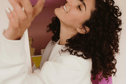 A graphic with a collage background of different people smiling and laughing, with a light mint overlay and the words "22 2022 Highlights" overlaid in block letters.