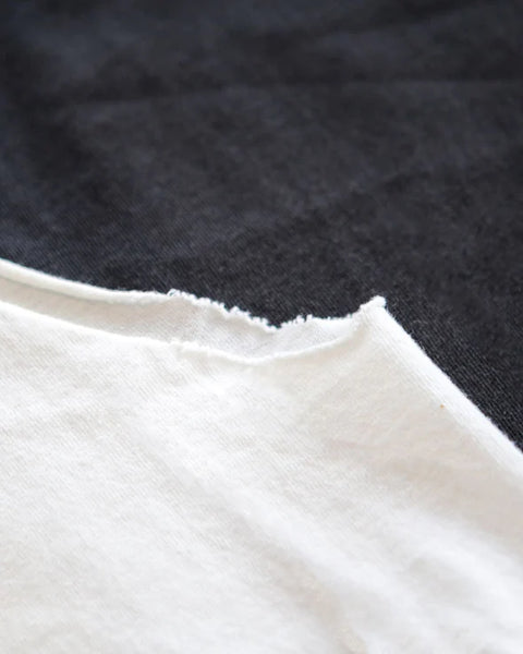 A distressed arm hole on the bubulez muscle tee.