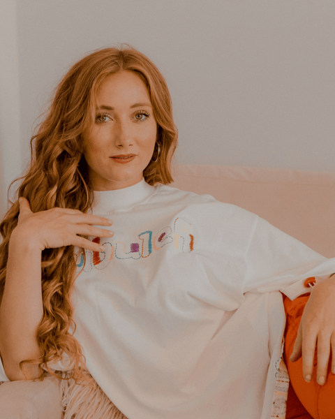 A model with red hair combing her hair and modeling the wonder thread oversized tee by bubuleh.