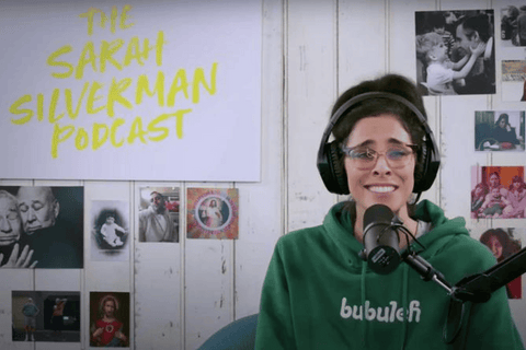 Jewish comedian and actor Sarah Silverman wears a green bubuleh hoodie during her Sarah Silverman podcast.