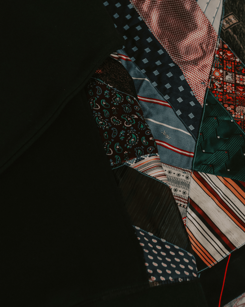 A close-up photo of upcycled, retro ties put together in a quilt.
