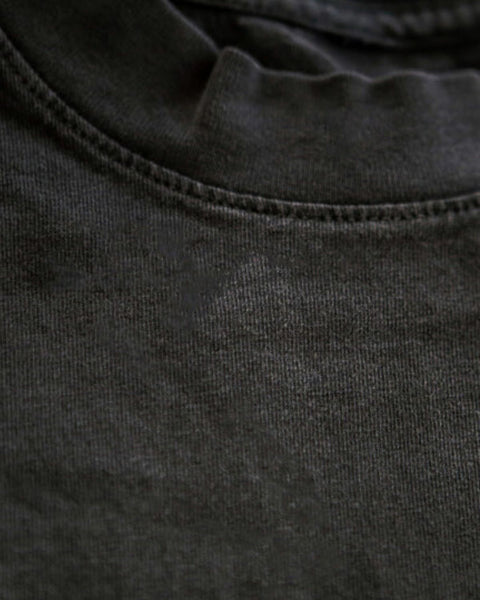 A closeup photo of a distressed vintage black faygeleh unisex genderless tank top