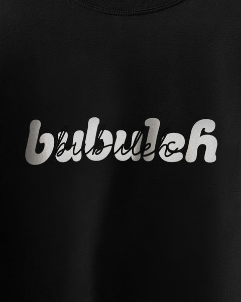 A closeup of a black unisex t-shirt showing the bubuleh logo in retro bubble letters with script saying bubuleh written over it.