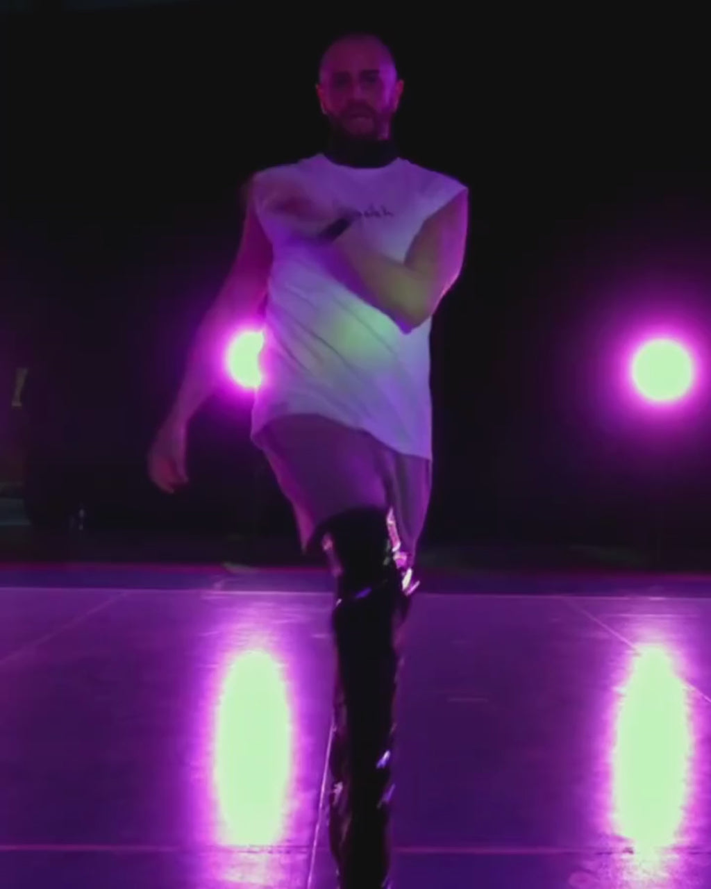 A video of celebrity choreographer Brian Friedman dancing in bubuleh's white faygeleh tank top and kiss my tuchus shorts, with black heels to Beyoncé in a dance class.