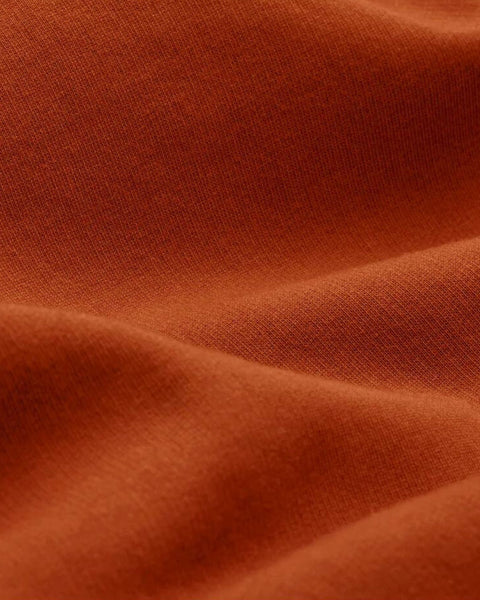 A closeup of bubuleh's cinnamon crewneck fabric, which is 100% organic cotton french terry.