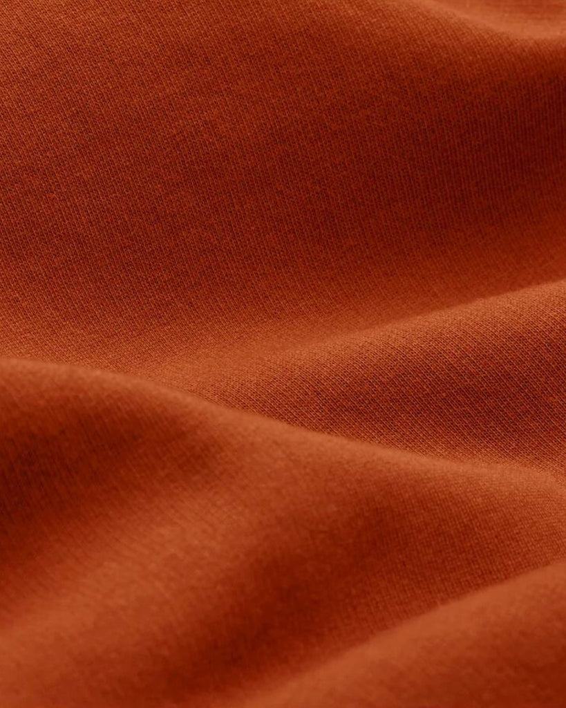A closeup of bubuleh's cinnamon crewneck fabric, which is 100% organic cotton french terry.