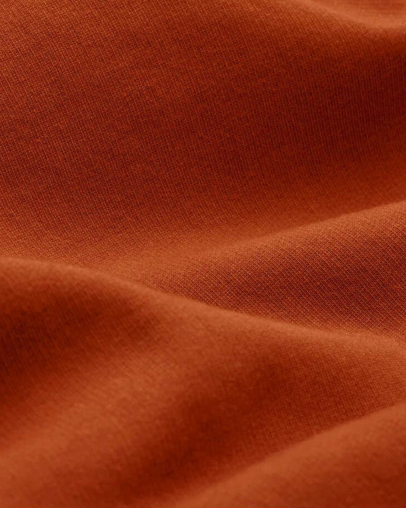 A closeup of bubuleh cinnamon french terry organic cotton with waves to show the feel of the fabric.