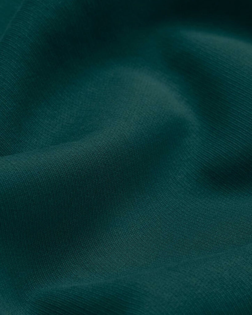 A closeup of bubuleh evergreen french terry organic cotton with waves to show the feel of the fabric.