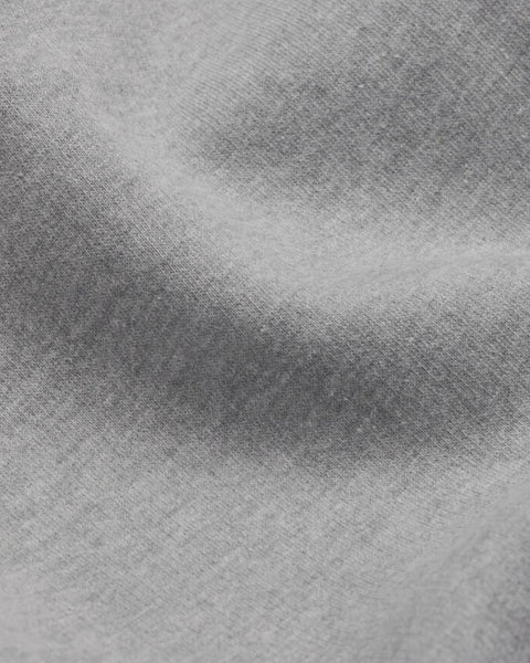 A closeup of bubuleh's heather gray crewneck fabric, which is 100% organic cotton french terry.
