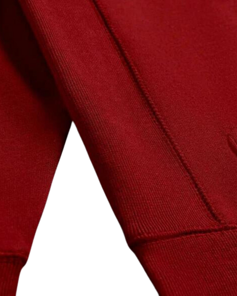 A detail closeup of the bubuleh handcrafted rosewood red heirloom hoodie showing expert stitching.