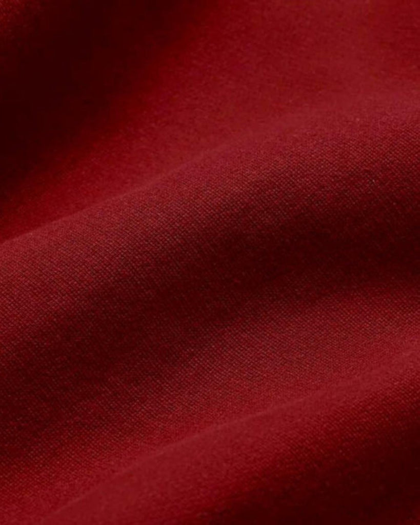 A closeup of bubuleh red french terry organic cotton with waves to show the feel of the fabric.